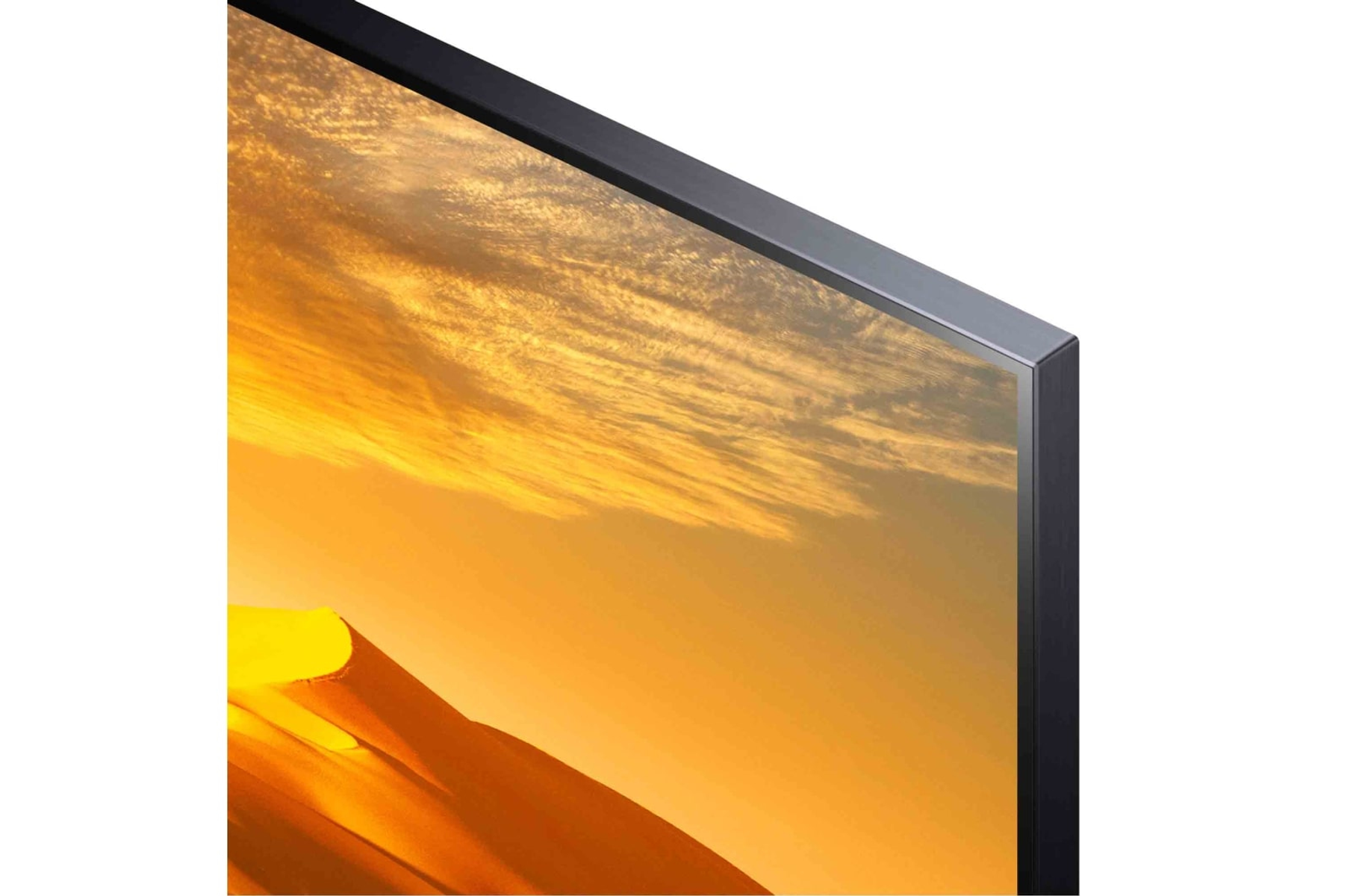 Primer plano de una esquina de pantalla de TV, mostrando marco negro e imagen de paisaje con puesta de sol.