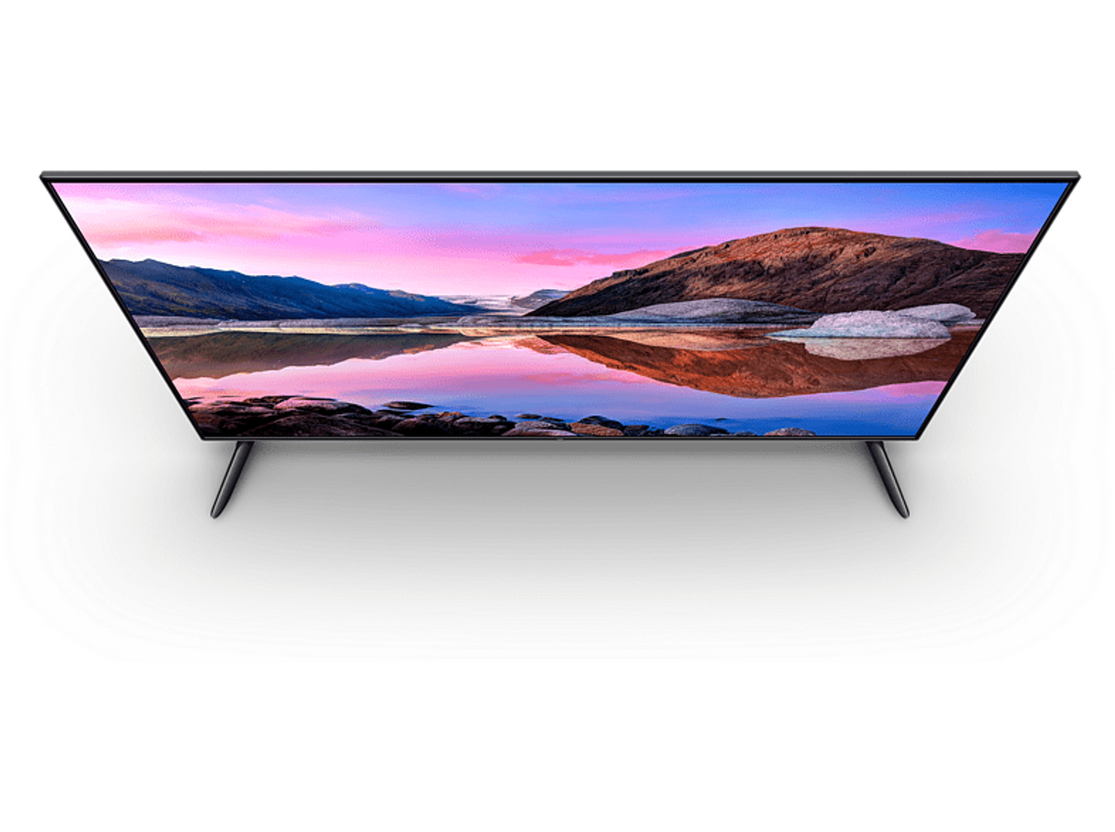 Tv-scherm met landschap, bergen en water, zwart frame en poten. Van bovenaf gezien.