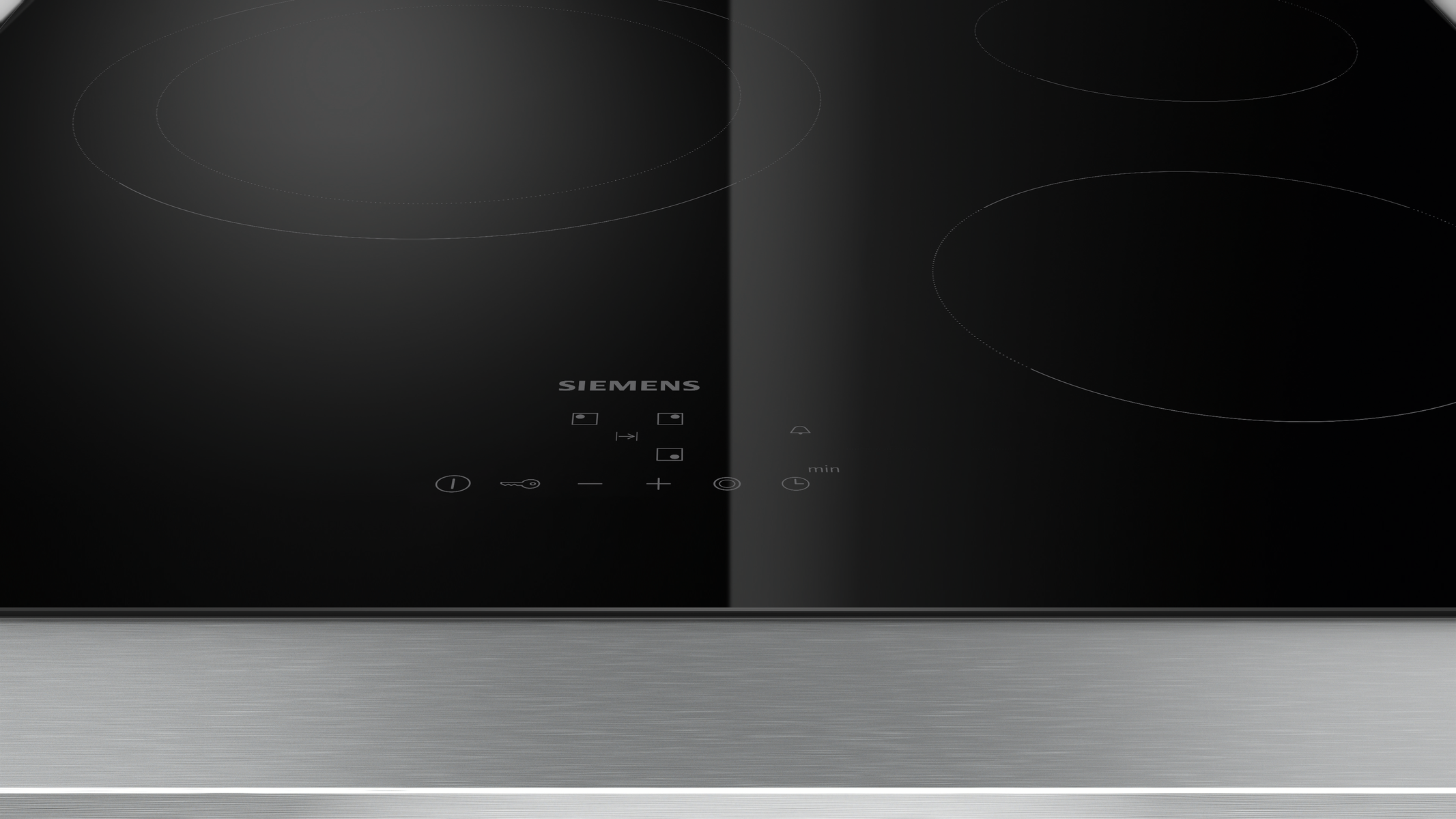 Czarna płyta grzewcza ze szkła z czterema okrągłymi palnikami. Widoczna marka Siemens.