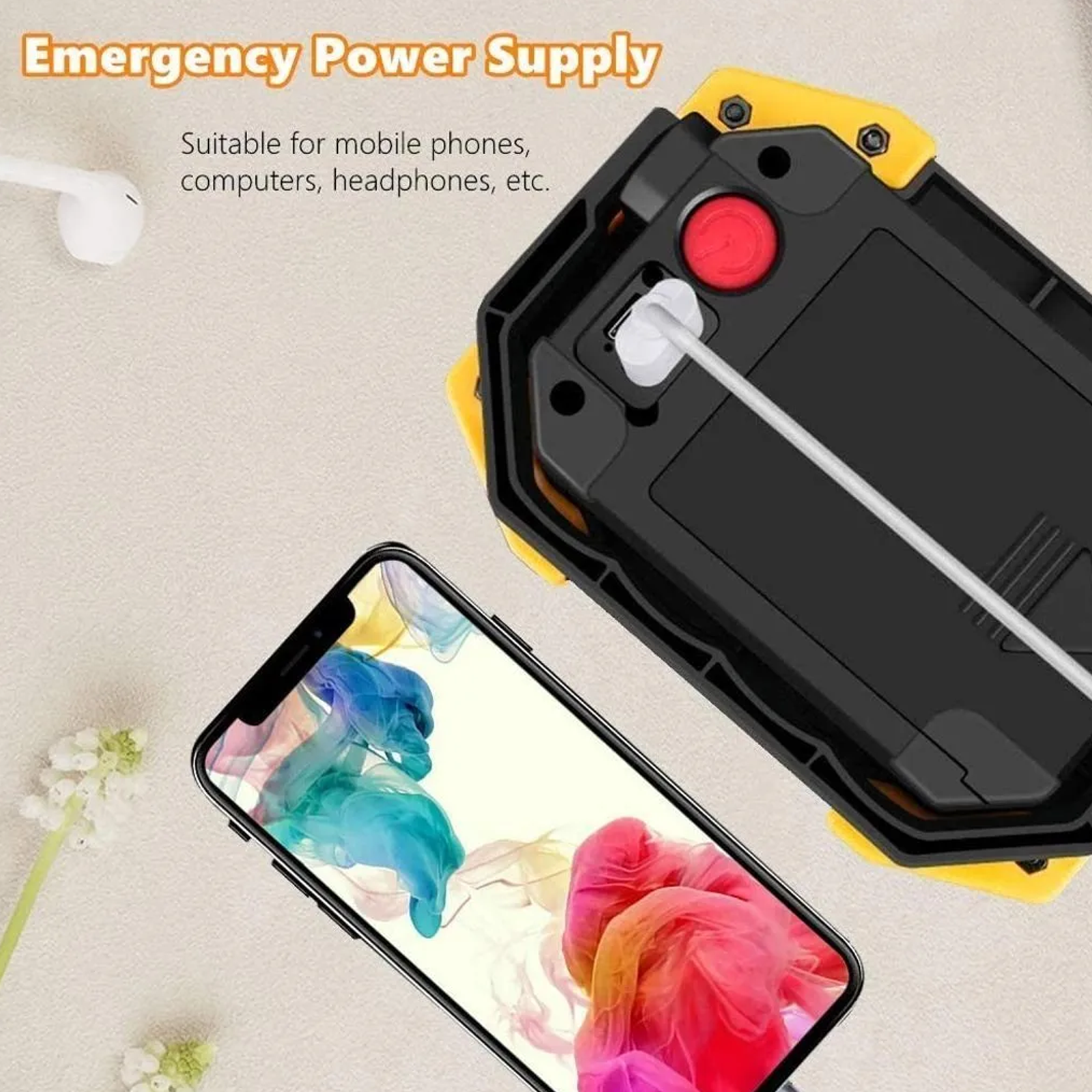 Un suministro de energía de emergencia negro y amarillo con un teléfono cargando y auriculares blancos cerca.