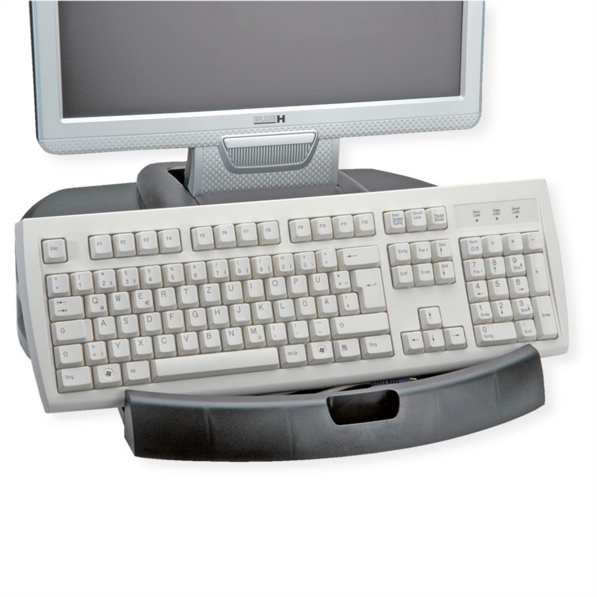 Eine weiße Tastatur mit Tasten, die auf einer schwarzen Halterung unter einem Computermonitor liegt.