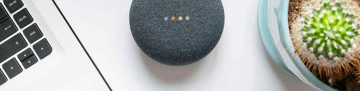 Gå med i MediaMarkts affiliate-program! På bilden: En laptop står på ett bord brevid en succulent och en Google-assistent