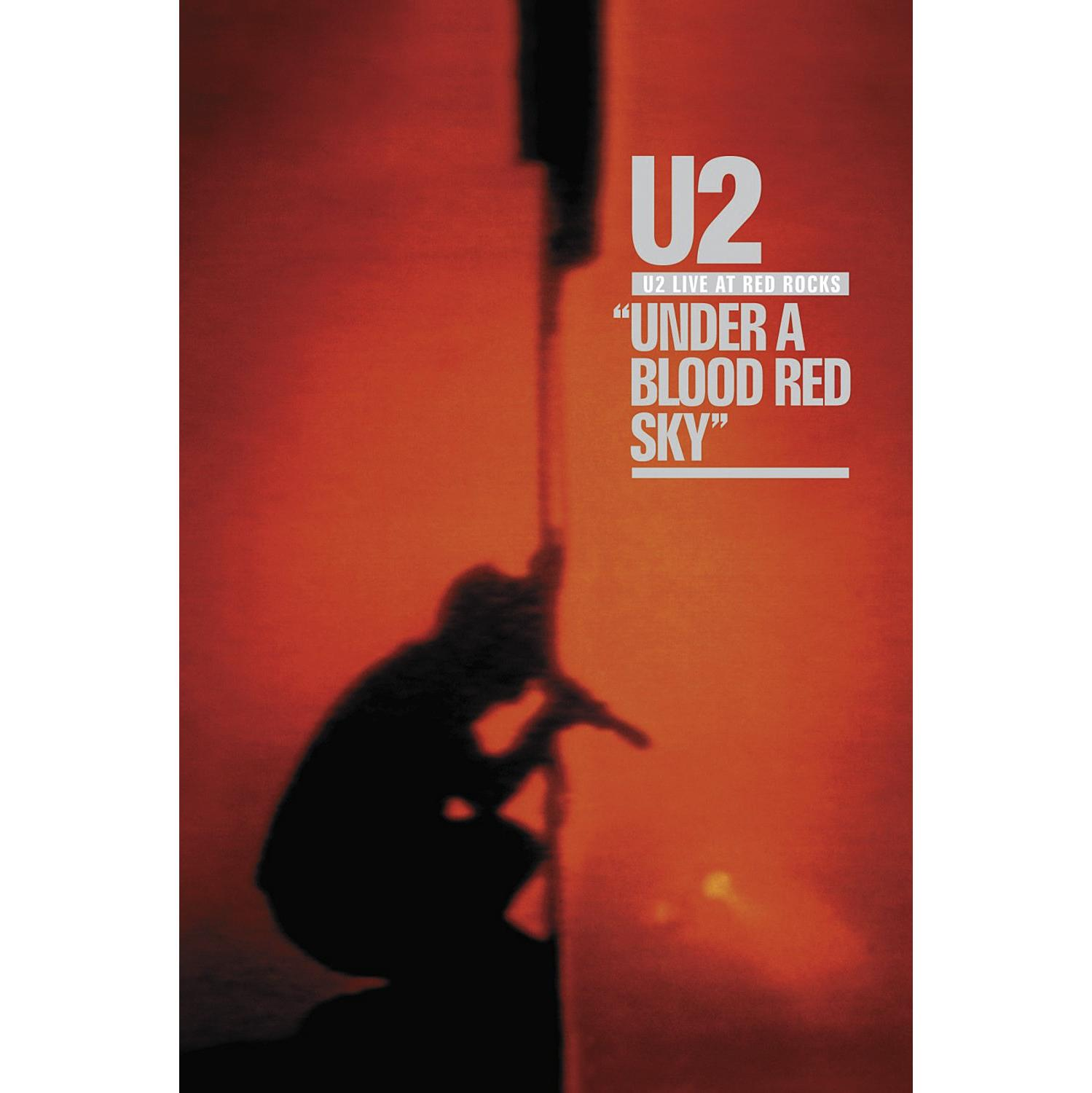 U2-Albumcover: Silhouette einer Person mit Mikrofon. Roter Hintergrund und Text.