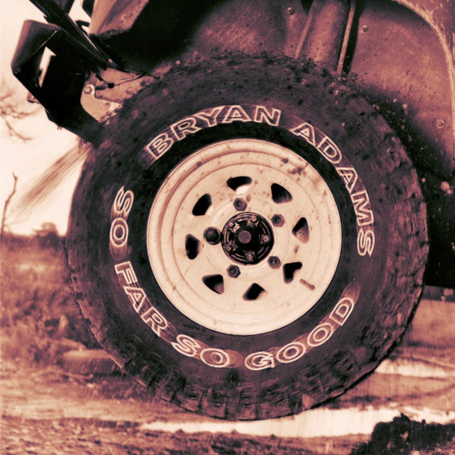 Bryan Adams Albumcover. Autoreifen mit weißer Schrift auf einer schlammigen Straße.
