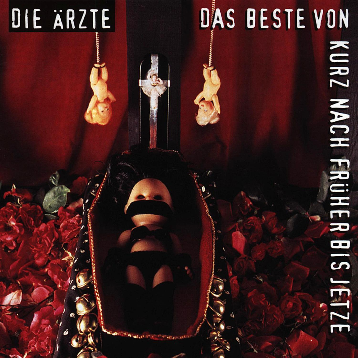 Albumcover: Puppen hängen, Puppe in einem Sarg mit Rosen, schwarzer Hintergrund, Text: Die Ärzte.