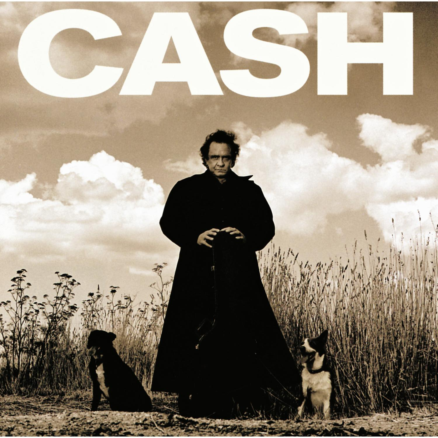 Albumcover von Johnny Cash in einem schwarzen Mantel, mit zwei Hunden. Über einem Feld mit bewölktem Himmel.