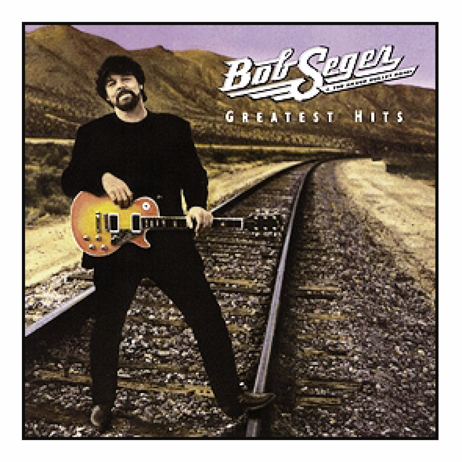 Albumcover mit Bob Seger, der eine Gitarre hält und auf Bahngleisen steht.