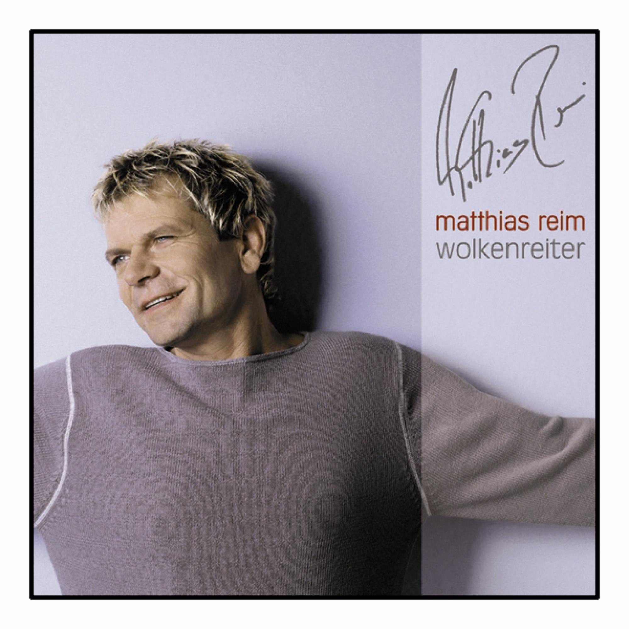 Albumcover: Mann mit blonden Haaren, lächelnd, trägt Pullover, mit Signatur und Text.