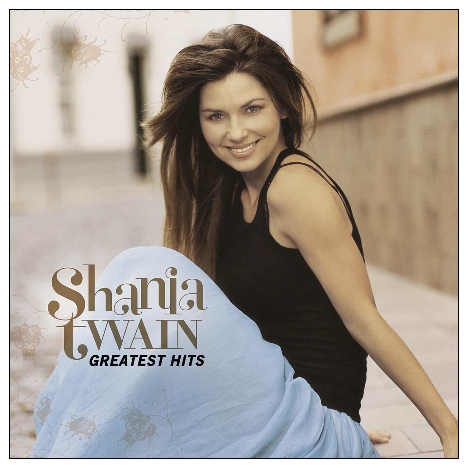 Shania Twain Albumcover: Sängerin lächelt, trägt ein schwarzes Top und blauen Rock, sitzt.