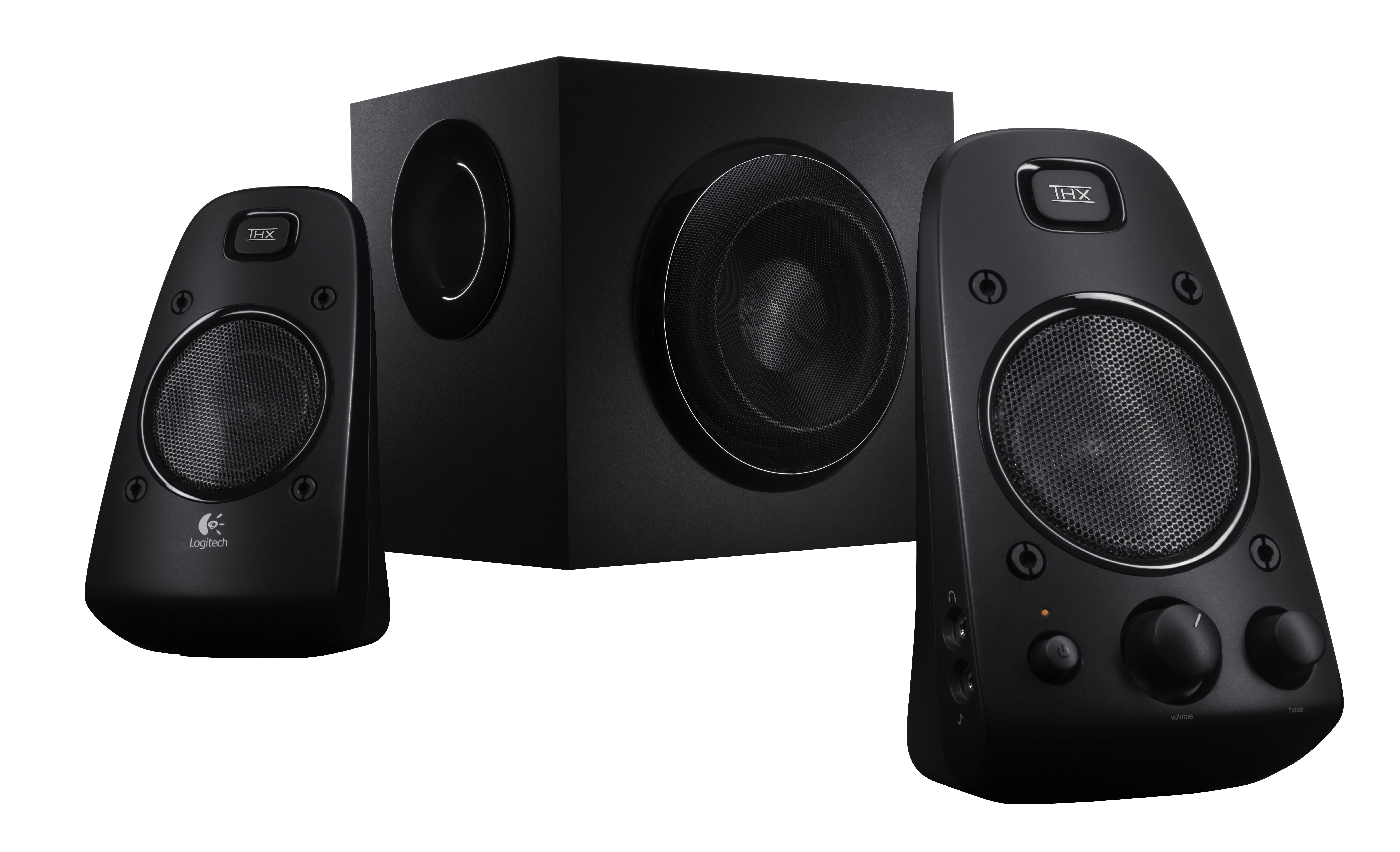 A set of three black speakers. The central one is a subwoofer.