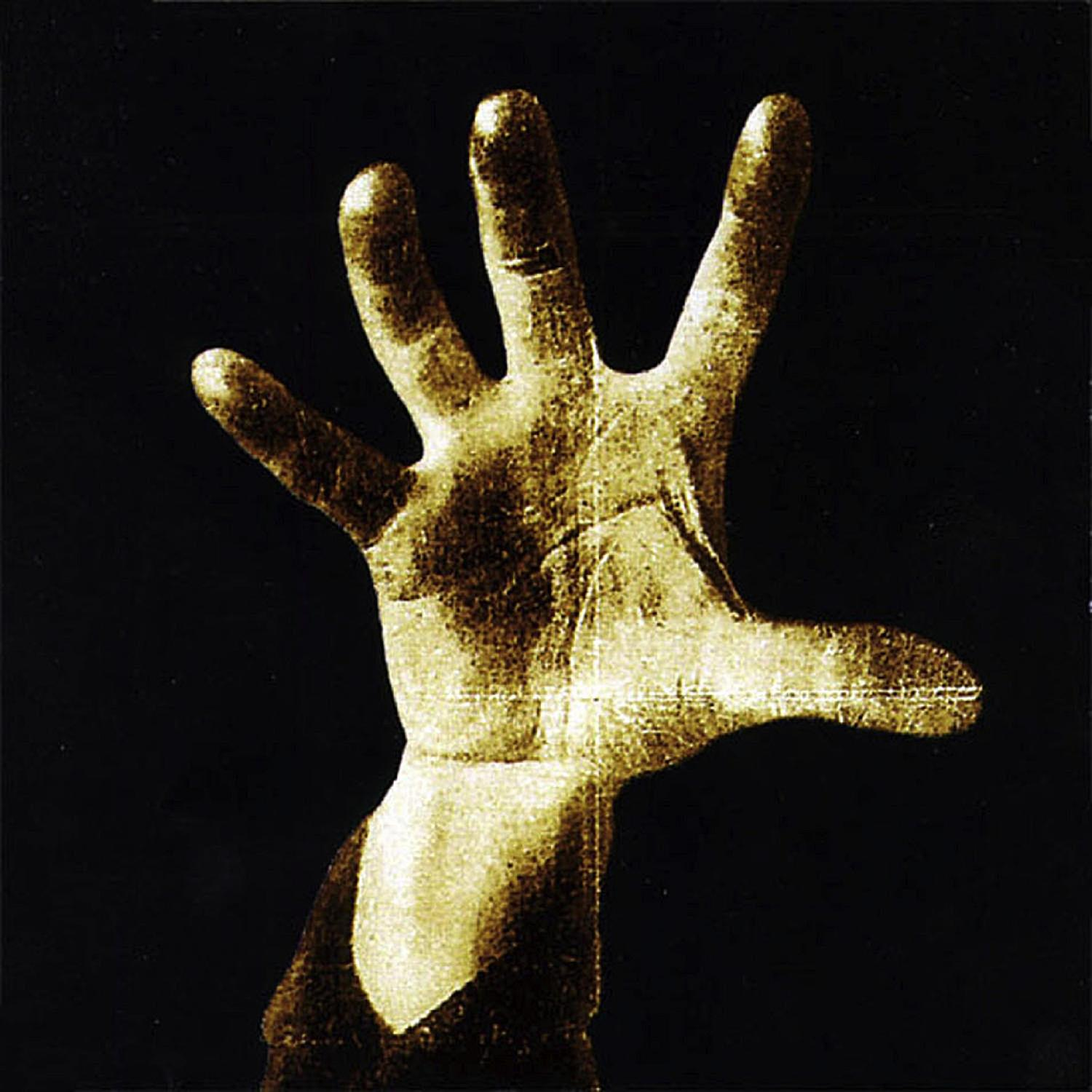 Albumhoes met een gouden hand tegen een zwarte achtergrond. De hand is open, vingers gespreid.