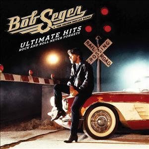 Albumcover mit einem Mann, der auf einem roten Auto sitzt. Bahnübergangsschild sichtbar.