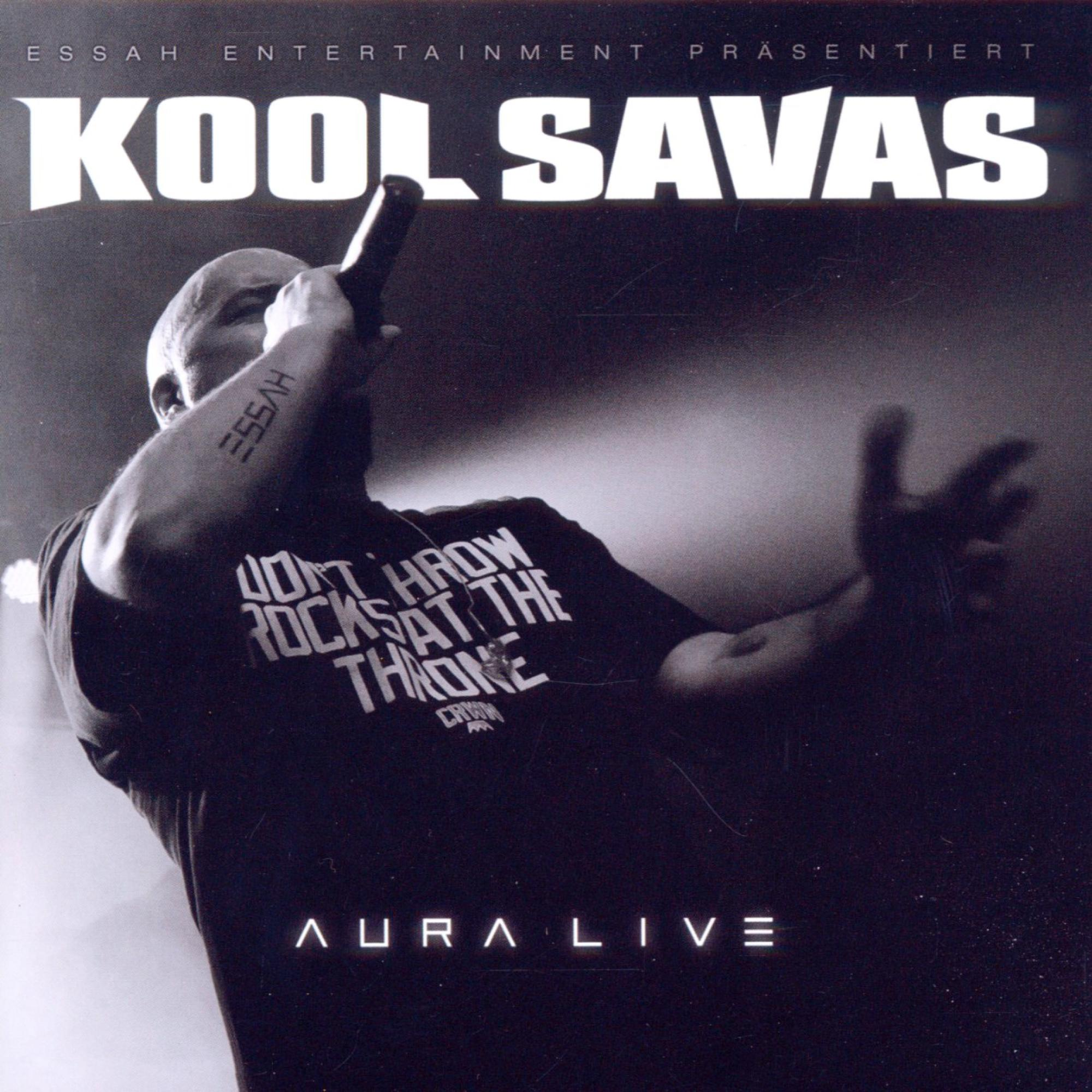 Albumcover mit einem kahlen Mann, der ein Mikrofon hält, Text 'KOOL SAVAS' und 'AURA LIVE'.