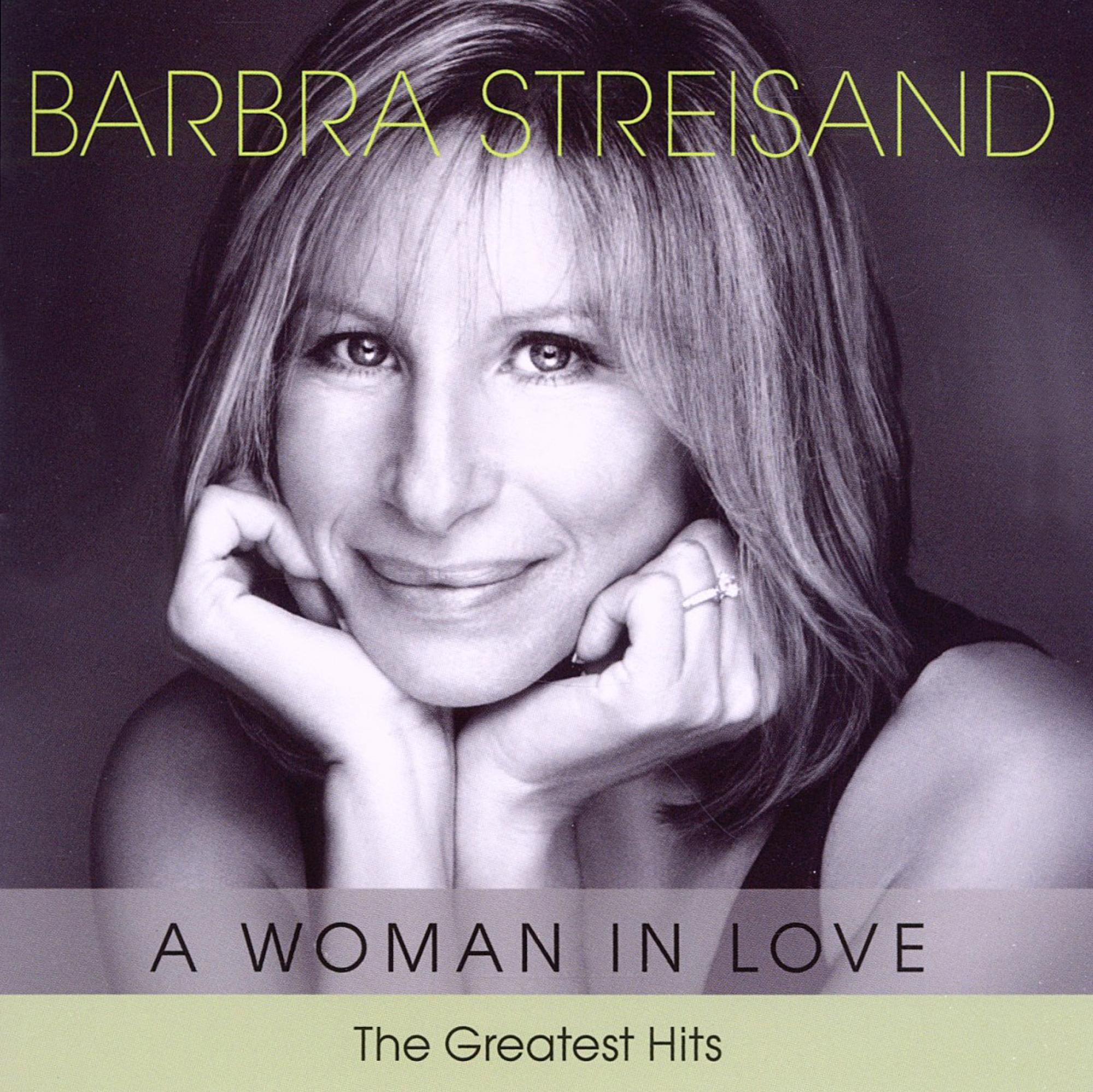 Albumcover mit Barbra Streisand mit sanftem Lächeln. Der Albumtitel lautet 'A Woman In Love' und 'The Greatest Hits'.