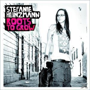 Albumcover von Stefanie Heinzmann. Sie steht auf einer Straße, trägt Brille und Jacke.