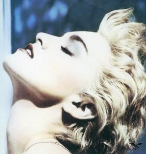 Bild von Madonnas Gesicht, nach oben blickend mit geschlossenen Augen, blondes Haar.