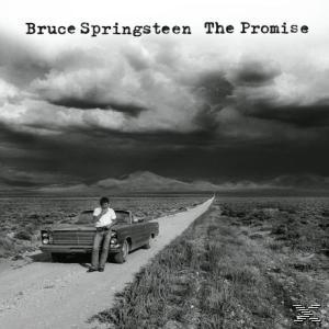 Bruce Springsteen Albumcover. Ein Mann lehnt an einem Auto auf einer Straße mit bewölktem Himmel.