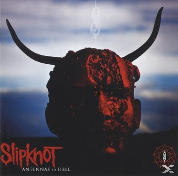 Slipknot Albumcover: Ein dämonischer Kopf mit Hörnern, rotes Gesicht, auf blauem Hintergrund.
