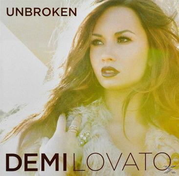 Demi Lovato auf einem CD-Cover mit dem Titel 'Unbroken'. Sie hat lange Haare und einen Pelzmantel.