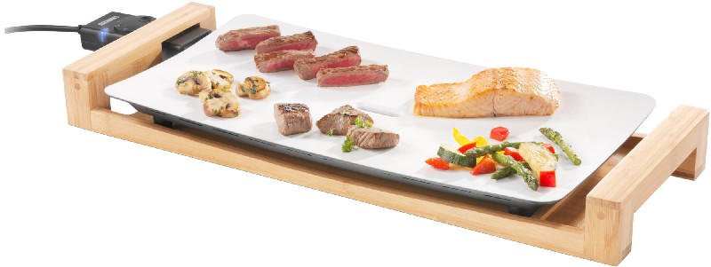 Electric grill with cooked food: steak, mushrooms, salmon, vegetables, and other meat.