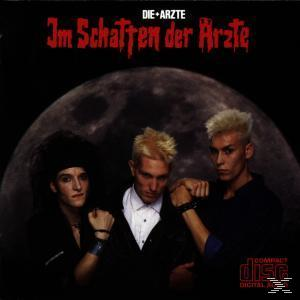 Albumcover mit drei Männern in dunkler Kleidung und großem Mond im Hintergrund.
