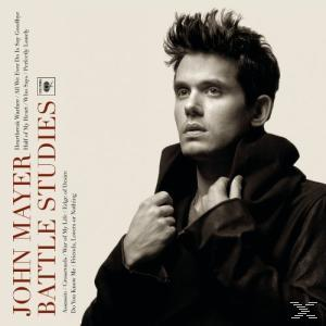 John Mayer album borító. Egy kabátos férfi jobbra néz. A 'Battle Studies' albumcím látható.