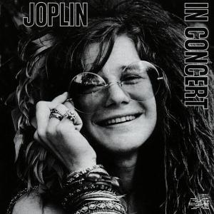 Albumcover: Janis Joplin im Konzert. Sie trägt eine runde Brille, Armbänder und lächelt.