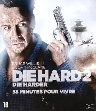 Filmposter van 'Die Hard 2'. Bruce Willis houdt een pistool vast, met tekst en een luchthaven.