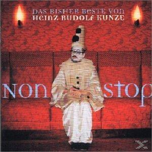 Albumcover mit einem Mann in Clownkostüm auf einem roten Sofa. Text: 'Das bisher Beste von Heinz Rudolf Kunze'.