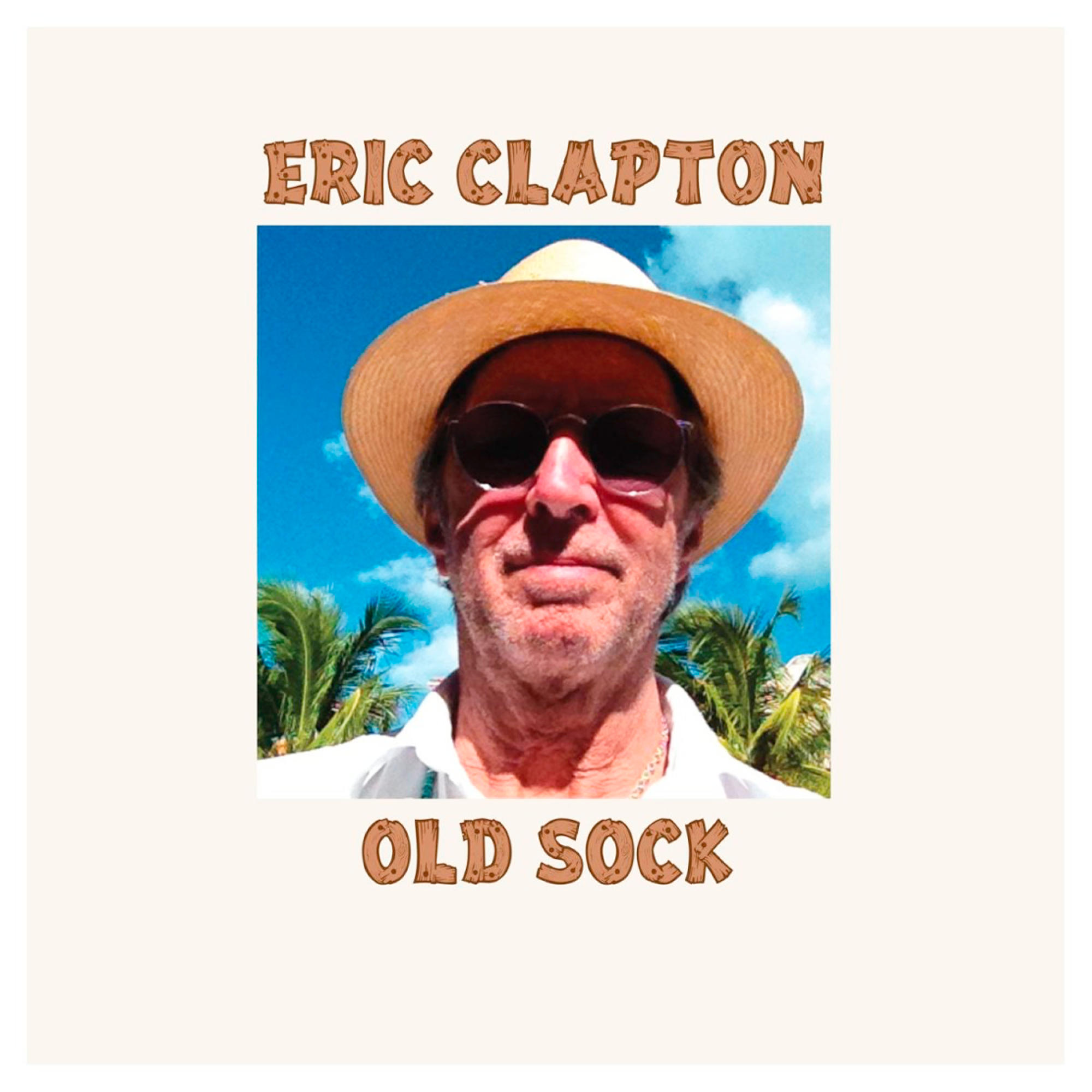 Pochette d'album : Eric Clapton avec lunettes de soleil et chapeau, ciel bleu et palmiers, texte 'OLD SOCK'.