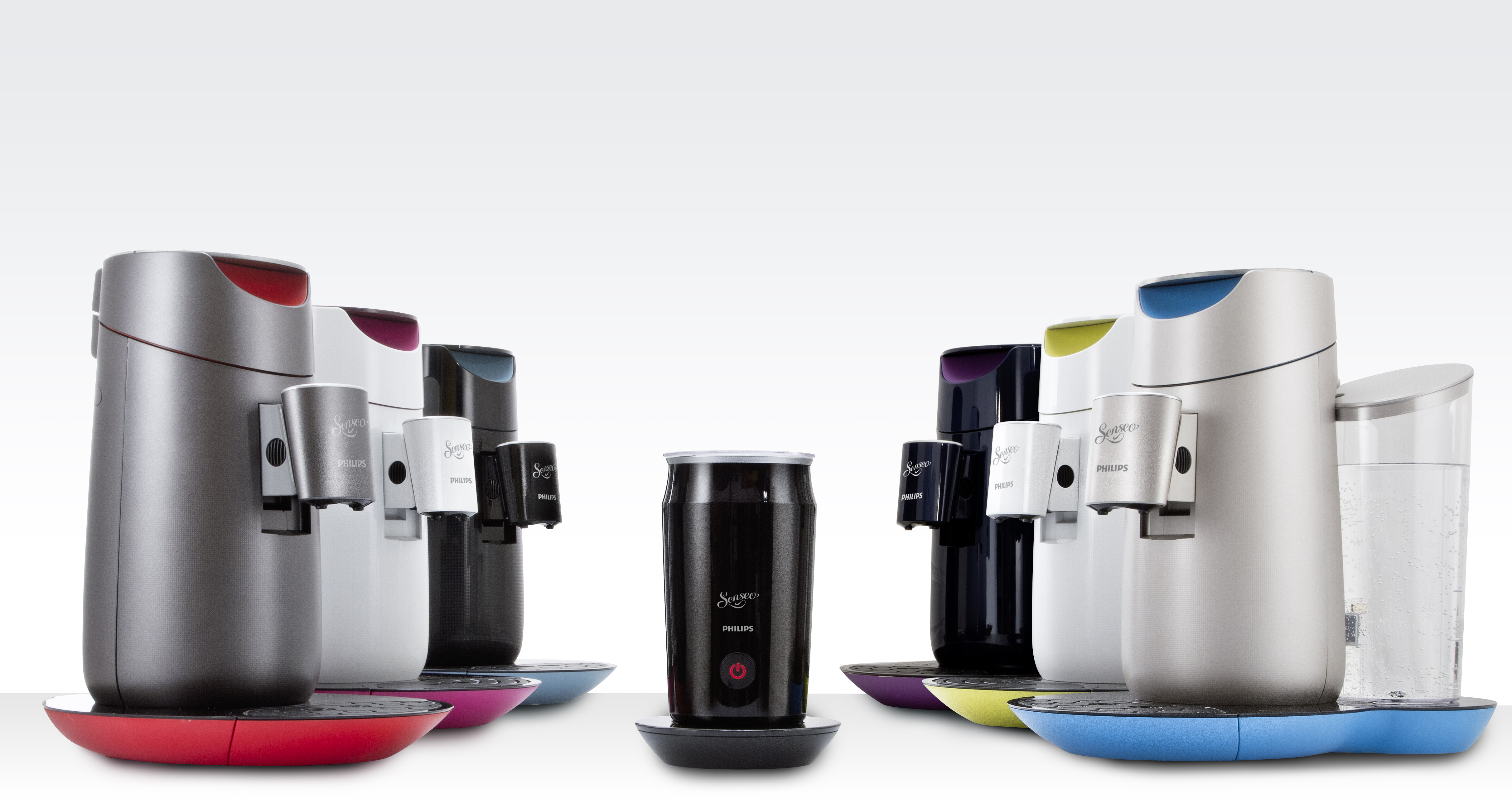 Eine Sammlung silberner und schwarzer Philips Senseo Kaffeemaschinen. Sie stehen auf unterschiedlich farbigen Sockeln.