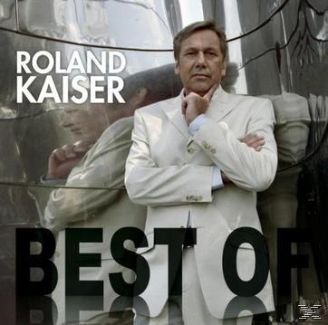 Albumcover mit Roland Kaiser. Er trägt einen weißen Anzug und steht vor einem metallischen Hintergrund.