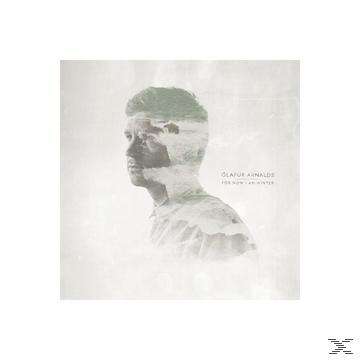 Albumcover: Gesicht eines Mannes mit Landschaft überlagert, dezente Farben, weißer Hintergrund.