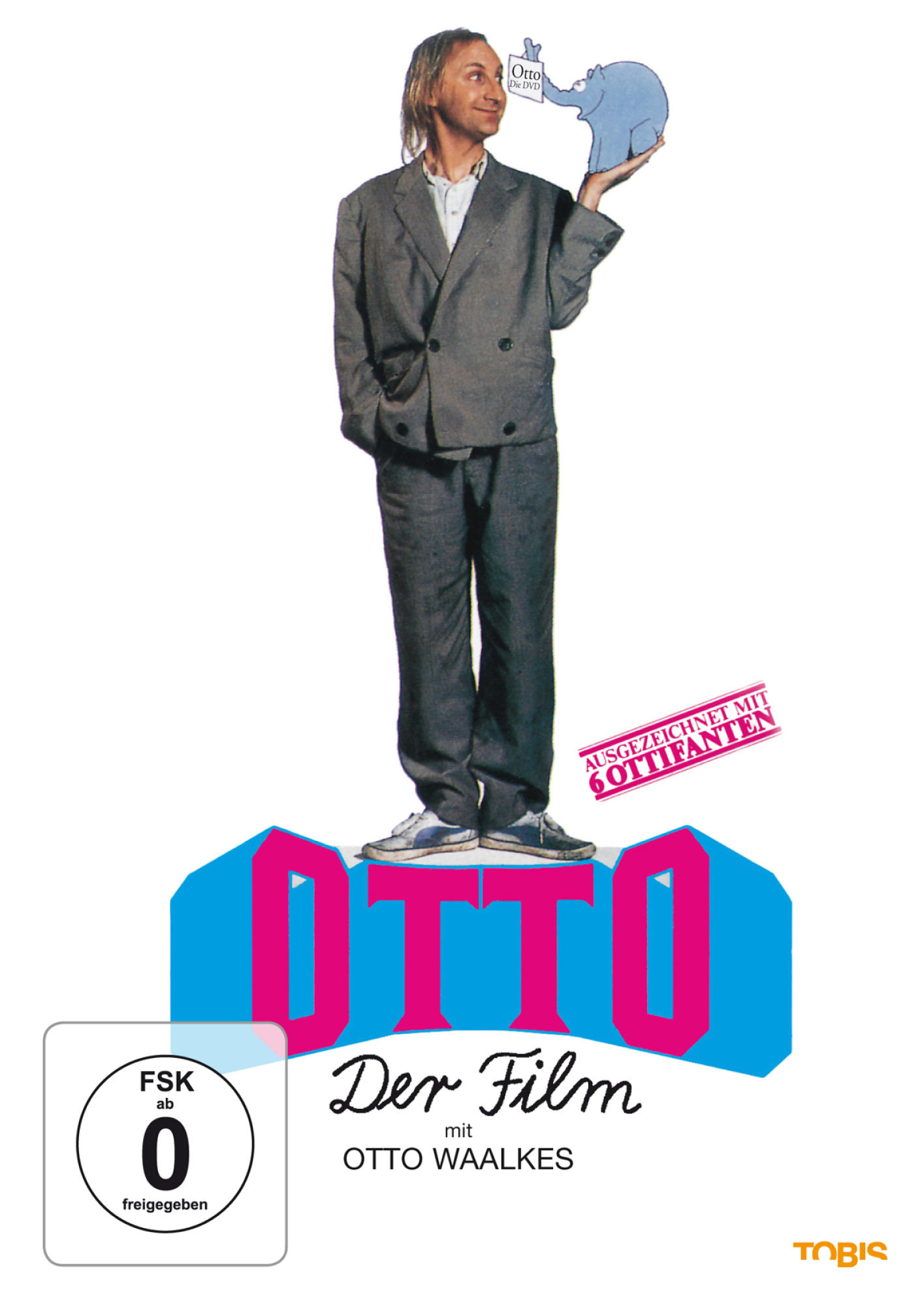 Otto Waalkes steht auf einer blauen Plattform. Er hält einen kleinen Elefanten. DVD-Cover mit Text.