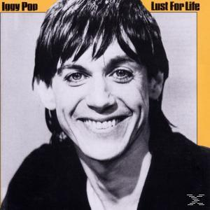 Iggy Pop lächelt auf dem Albumcover, mit dem Text "Lust For Life" über seinem Kopf.