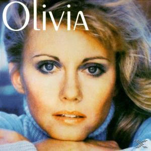 Nahaufnahme einer Frau mit blonden Haaren, blauen Augen und dem Namen "Olivia" über ihr.