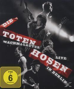 Albumcover mit einer Gruppe von Musikern, die live auf der Bühne auftreten.