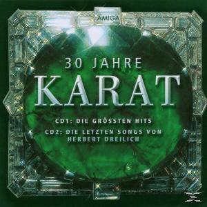 CD-Cover mit dem Titel '30 Jahre Karat', einem grünen Edelstein und einem silbernen Rahmen.