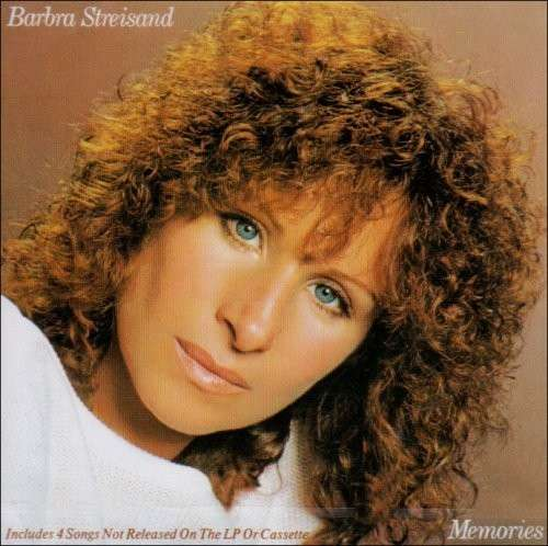 Album borító: Barbra Streisand, Memories. Közelkép az arcáról, göndör haj, kék szemek, fehér felső.