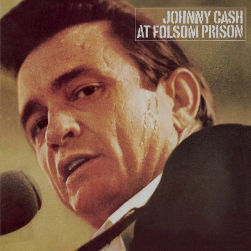 Johnny Cash at Folsom Prison album borítója, Cash közeli képe mikrofonnal. Szöveg a tetején.