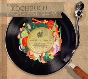 Albumcover-Kunst eines Plattenspielers mit Essen auf der Schallplatte. Der Titel ist Liedfett Kochbuch.