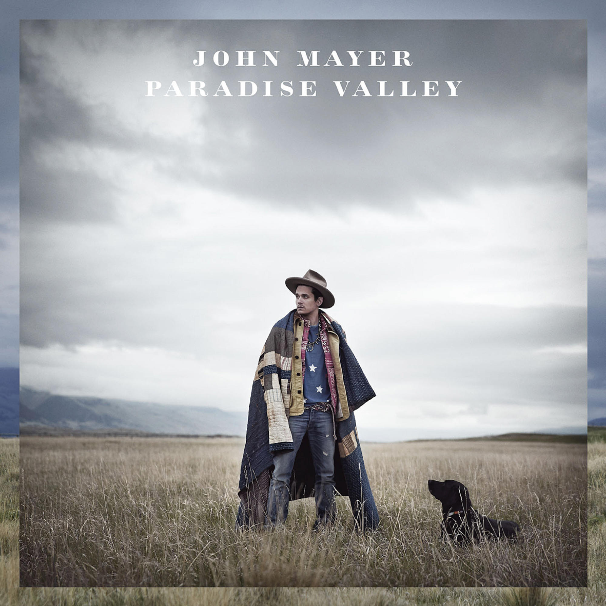 John Mayer auf einem Feld mit Hut und Decke, mit einem Hund. Titel: Paradise Valley.