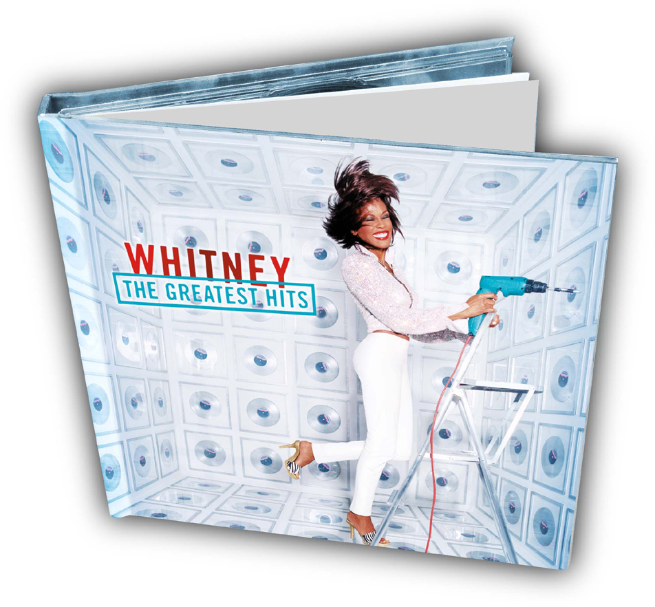 Albumcover: Whitney, The Greatest Hits. Frau hält Bohrmaschine, steht auf Leiter. Blauer Hintergrund.