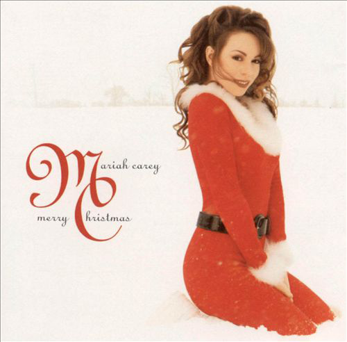 Mariah Carey Merry Christmas album borító. Piros Mikulás ruhát visel, és hóban ül.