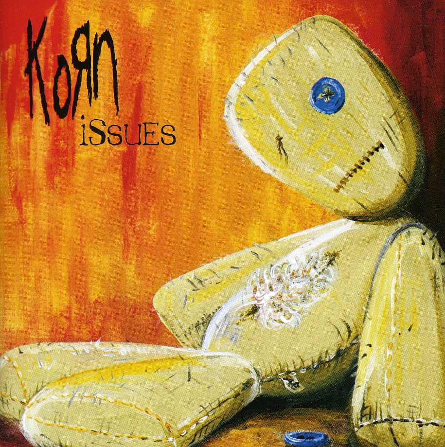 A Korn 'Issues' album borítója. Egy rongybaba narancssárga háttéren, kék gombbal.