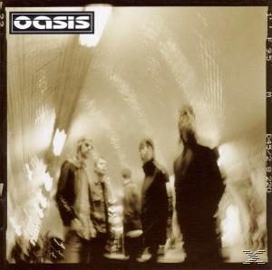 Oasis-Albumcover. Bandmitglieder in Sepia-Tönen, die in einem verschwommenen, beleuchteten Tunnel gehen.