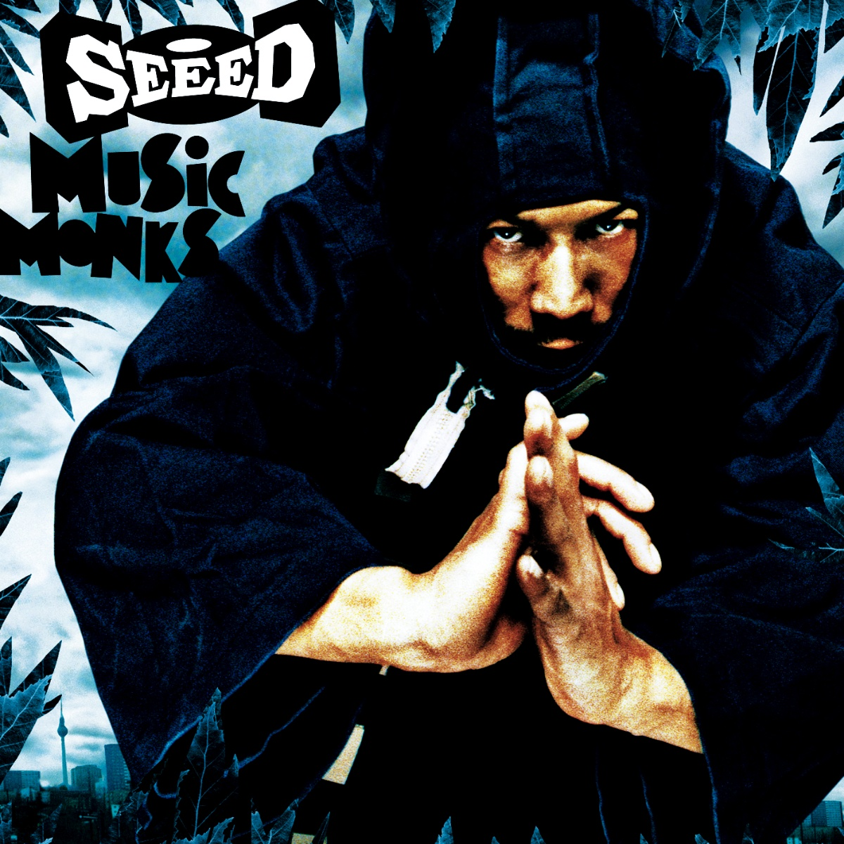 Albumcover mit einem Mann in Ninja-Outfit. Text sagt SEEED, MUSIC MONKS. Eine Stadt ist im Hintergrund.