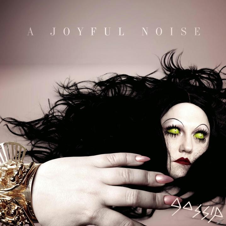 Albumcover: Puppengesicht mit schwarzem Haar, grünen Augen und roten Lippen. Ein goldenes Armband.
