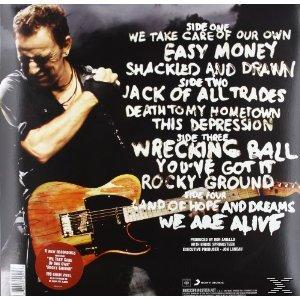Albumcover mit Titelliste und einem Mann, der eine Gitarre hält, Titel 'Wrecking Ball'.