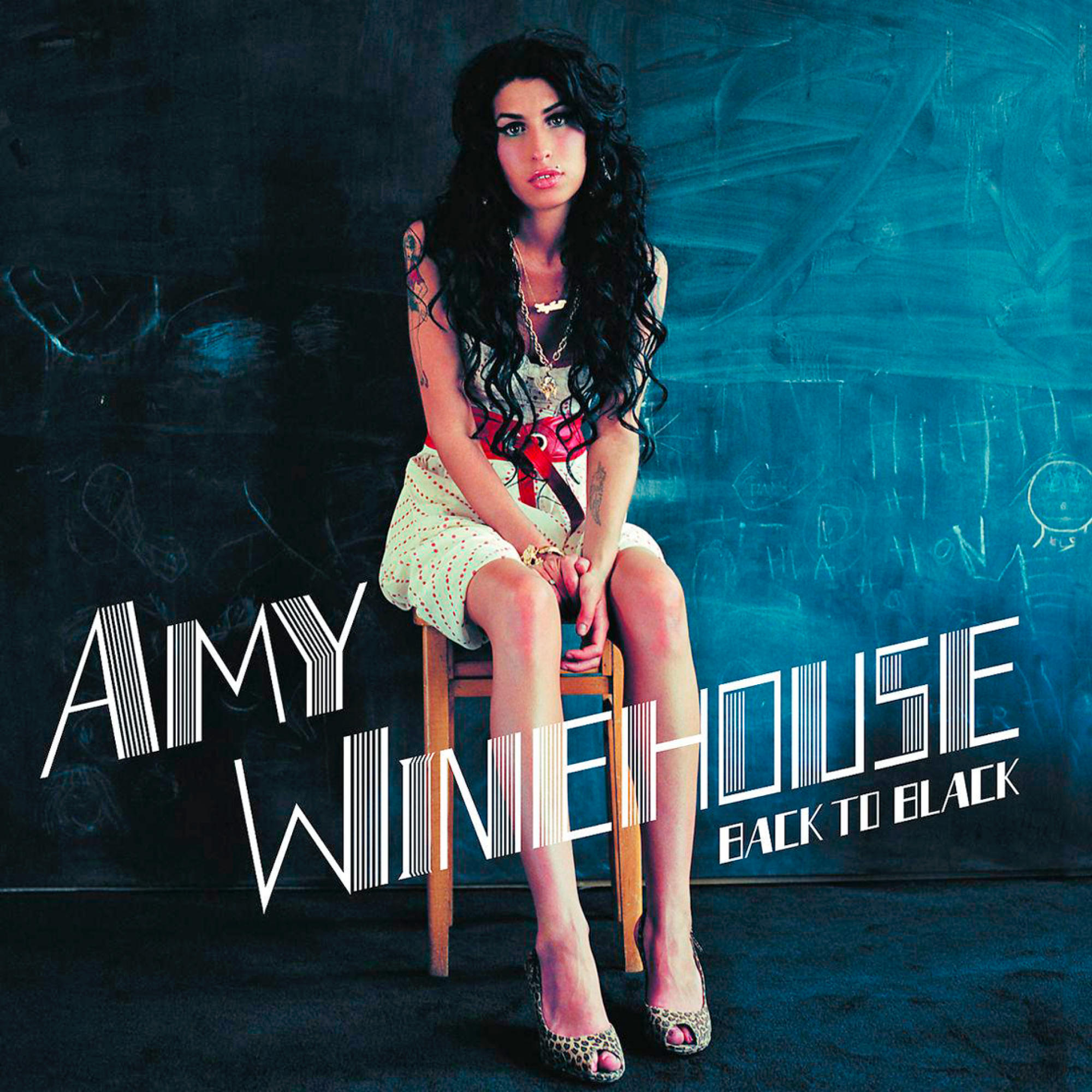 Albumcover: Amy Winehouse, Back to Black. Amy sitzt, Tafelhintergrund.